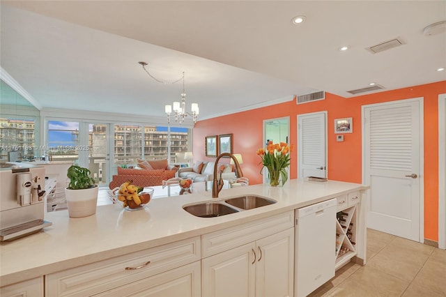 kitchen featuring a sink, visible vents, light countertops, and dishwasher