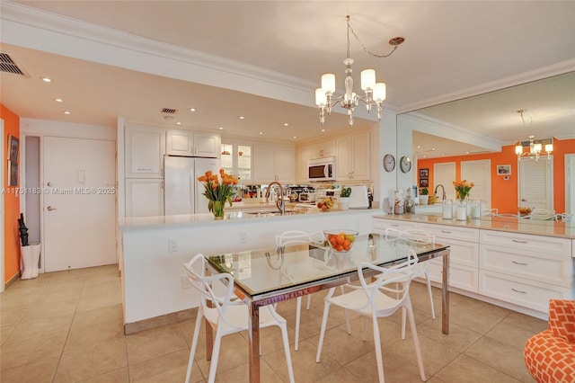 dining area with light tile patterned floors, visible vents, and an inviting chandelier