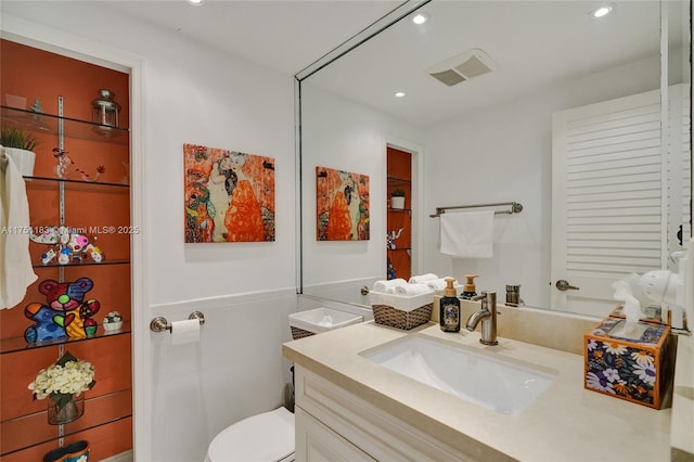 bathroom featuring recessed lighting, visible vents, vanity, and toilet