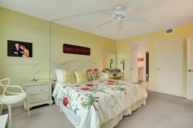 bedroom with visible vents, a ceiling fan, and light colored carpet