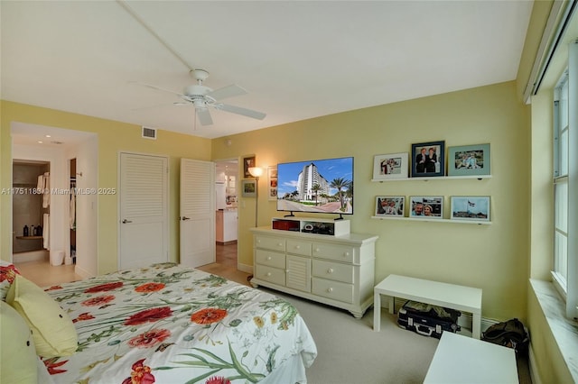 bedroom with a ceiling fan, light colored carpet, and visible vents