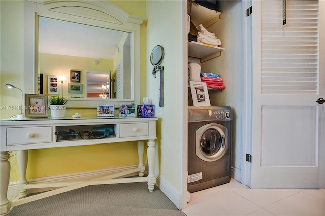 laundry area with washer / dryer, baseboards, laundry area, and light tile patterned flooring