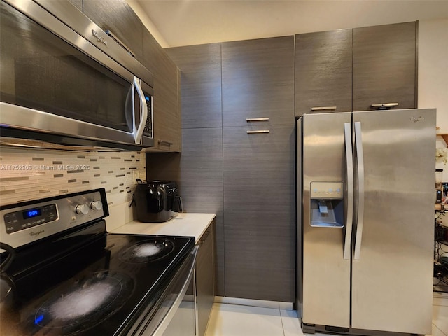 kitchen with stainless steel appliances, tasteful backsplash, modern cabinets, and light countertops
