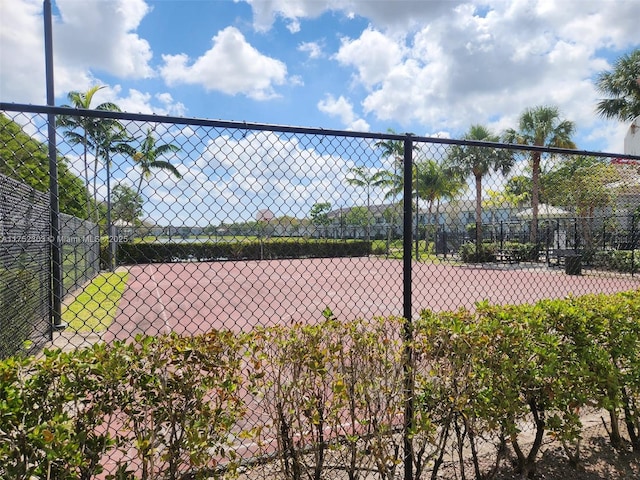 view of tennis court with fence