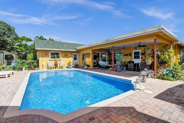 pool with a patio area and ceiling fan