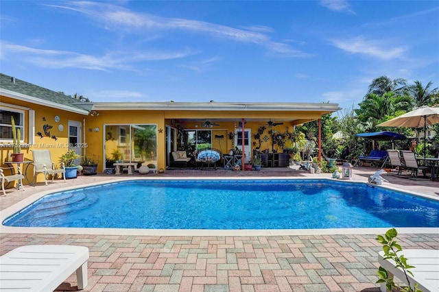 pool featuring a ceiling fan and a patio