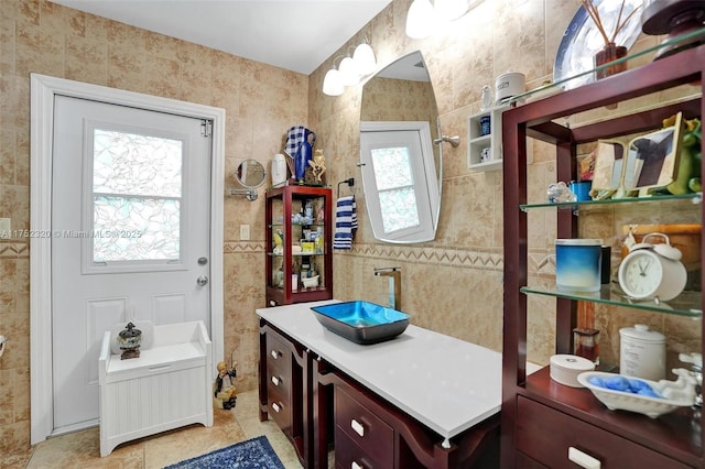 bathroom with vanity and tile walls