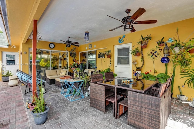 view of patio / terrace featuring an outdoor hangout area, ceiling fan, and outdoor dining area