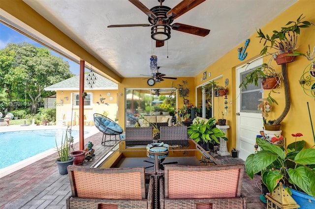 view of patio / terrace with an outdoor pool and ceiling fan