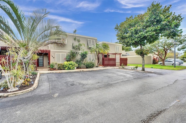 view of front of property with fence and stucco siding