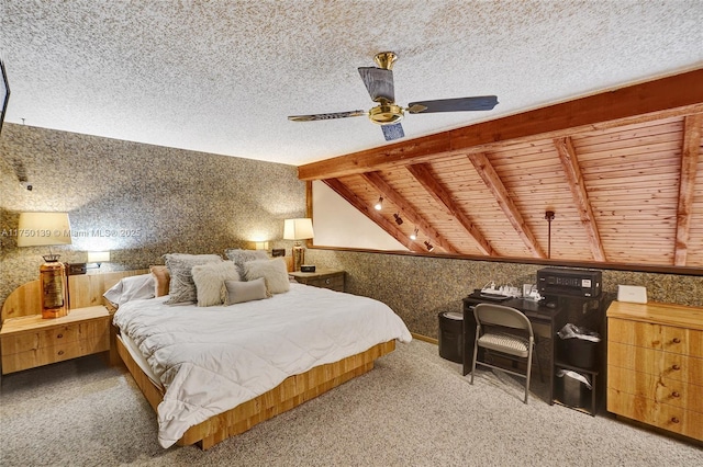 bedroom with lofted ceiling with beams, wallpapered walls, and a textured ceiling