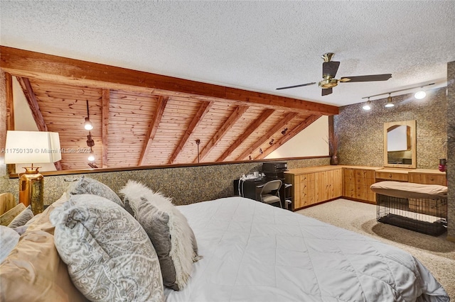 bedroom featuring vaulted ceiling with beams, rail lighting, light colored carpet, a textured ceiling, and wooden ceiling