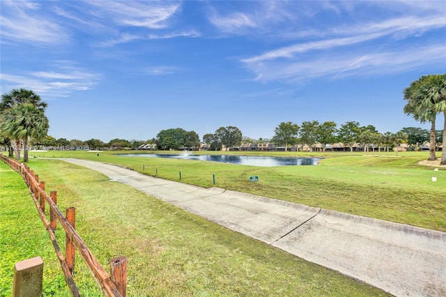 exterior space featuring a water view and fence