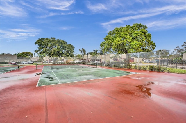 view of sport court featuring fence