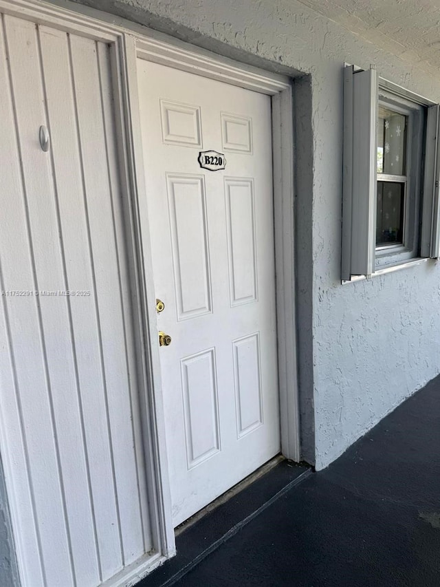 doorway to property featuring board and batten siding