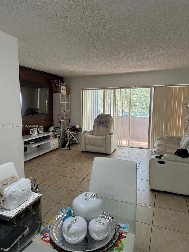 living area with a textured ceiling and light tile patterned flooring