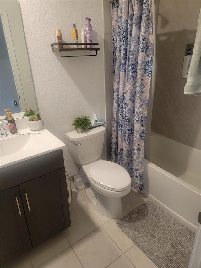 full bath with a textured wall, toilet, shower / tub combo, vanity, and tile patterned flooring