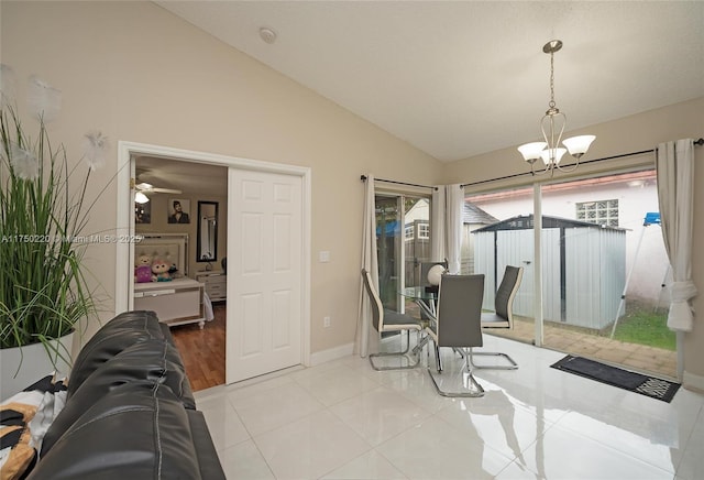 dining space featuring high vaulted ceiling, light tile patterned floors, baseboards, and an inviting chandelier