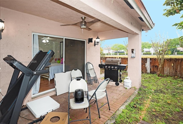 view of patio with fence private yard, ceiling fan, and area for grilling