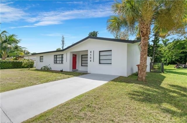 view of front of property featuring a front yard and stucco siding