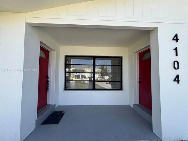 property entrance with stucco siding