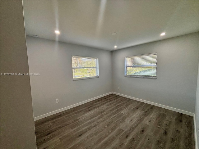 unfurnished room with recessed lighting, dark wood finished floors, and baseboards