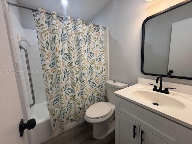 full bath with toilet, shower / tub combo with curtain, wood finished floors, and vanity