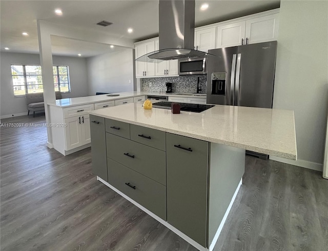 kitchen with visible vents, white cabinets, decorative backsplash, appliances with stainless steel finishes, and island exhaust hood