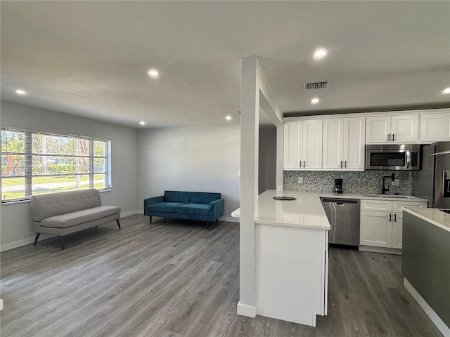 kitchen with visible vents, appliances with stainless steel finishes, tasteful backsplash, and light countertops