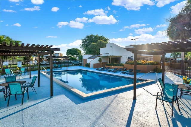 pool featuring fence, a pergola, and a patio