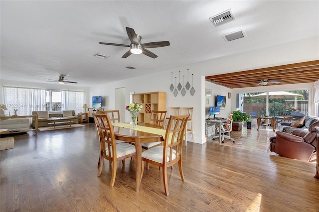 dining area featuring ceiling fan, wood finished floors, and visible vents