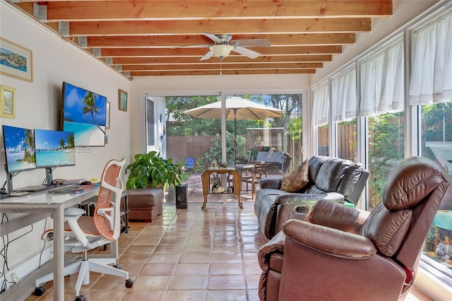 sunroom with a ceiling fan and beam ceiling