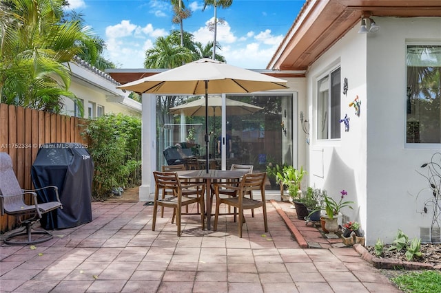 view of patio / terrace featuring fence, grilling area, and outdoor dining space