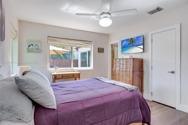 bedroom with light wood-style flooring, visible vents, and a ceiling fan