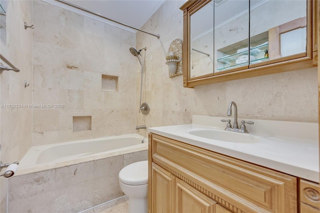 bathroom with tiled shower / bath, toilet, and vanity