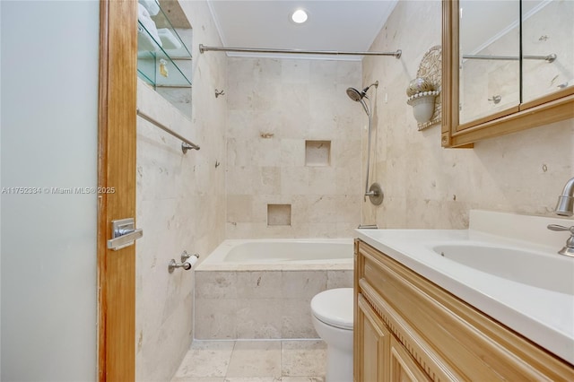 full bath featuring tiled shower / bath combo, toilet, tile walls, and vanity