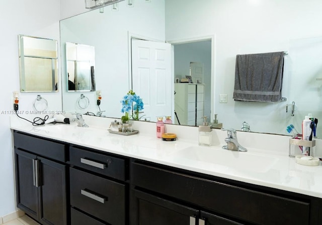 full bath with double vanity, a sink, and a shower stall