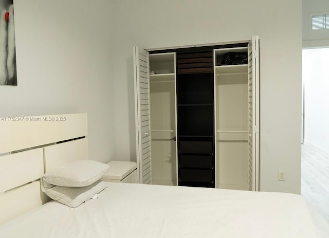 unfurnished bedroom featuring visible vents and a closet