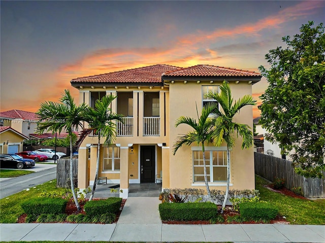 11669 SW 247th St, Homestead, FL 33032 - mediterranean / spanish-style home featuring a tile roof, fence, a balcony, and stucco siding