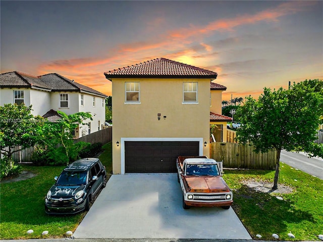 mediterranean / spanish house featuring a garage, driveway, a tile roof, fence, and stucco siding