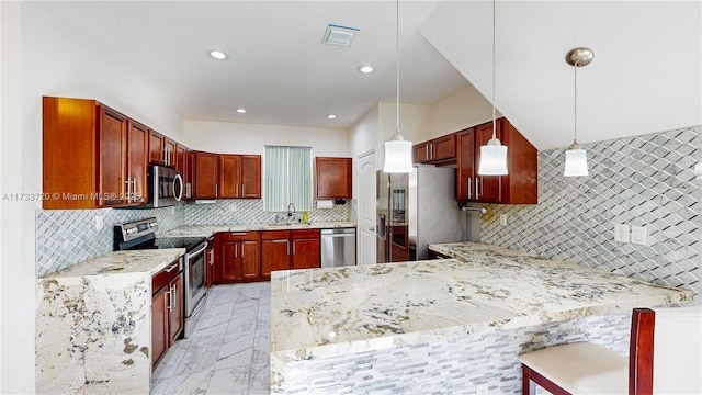 kitchen with visible vents, appliances with stainless steel finishes, hanging light fixtures, a peninsula, and a sink