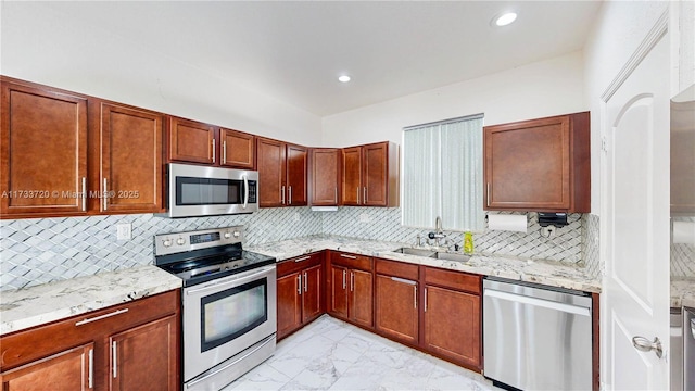 kitchen featuring recessed lighting, stainless steel appliances, a sink, marble finish floor, and decorative backsplash