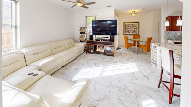 living room featuring marble finish floor, visible vents, and ceiling fan