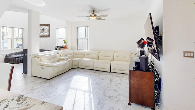 living room with lofted ceiling, marble finish floor, and a ceiling fan