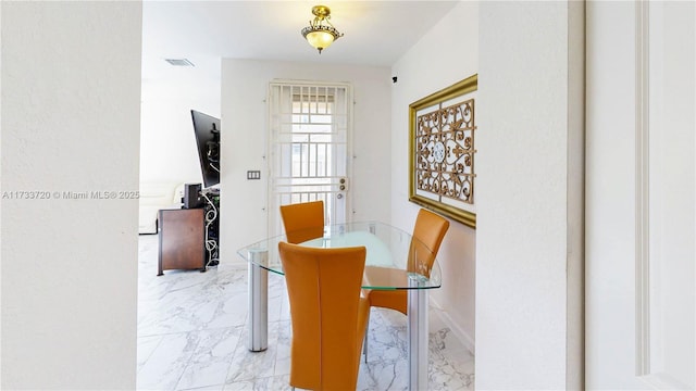 dining space featuring marble finish floor and visible vents