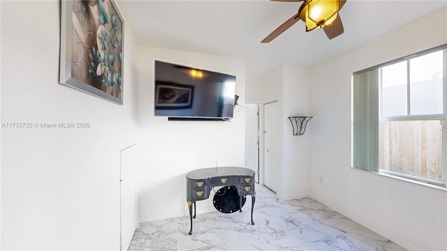 hallway with marble finish floor and baseboards