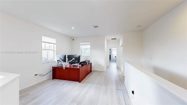 home office featuring light wood-type flooring, baseboards, visible vents, and recessed lighting