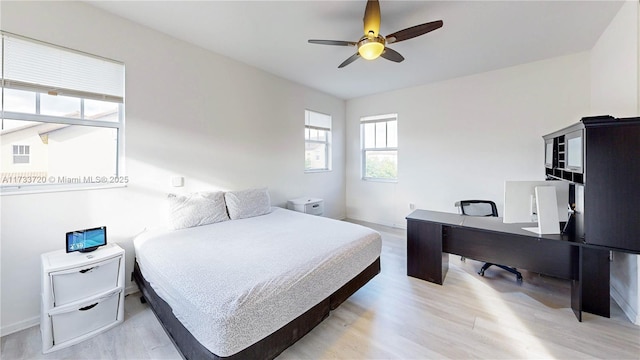 bedroom with ceiling fan and light wood-style floors