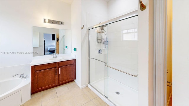 bathroom with a garden tub, connected bathroom, a shower stall, vanity, and tile patterned flooring