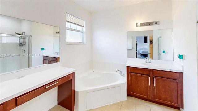 ensuite bathroom with ensuite bathroom, a garden tub, two vanities, a sink, and a stall shower